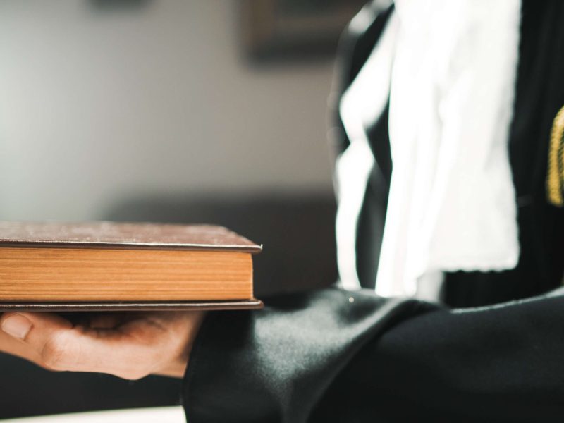 legal-professional-holding-book-wearing-court-gown-2026-09-22-00-21-21-utc